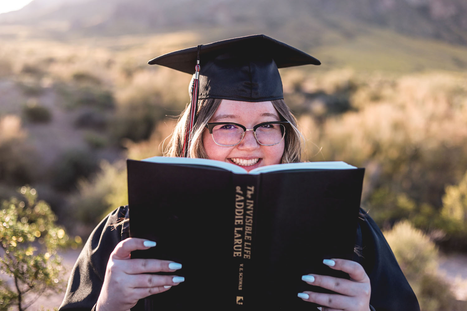 Graduate outside with her nose in a book