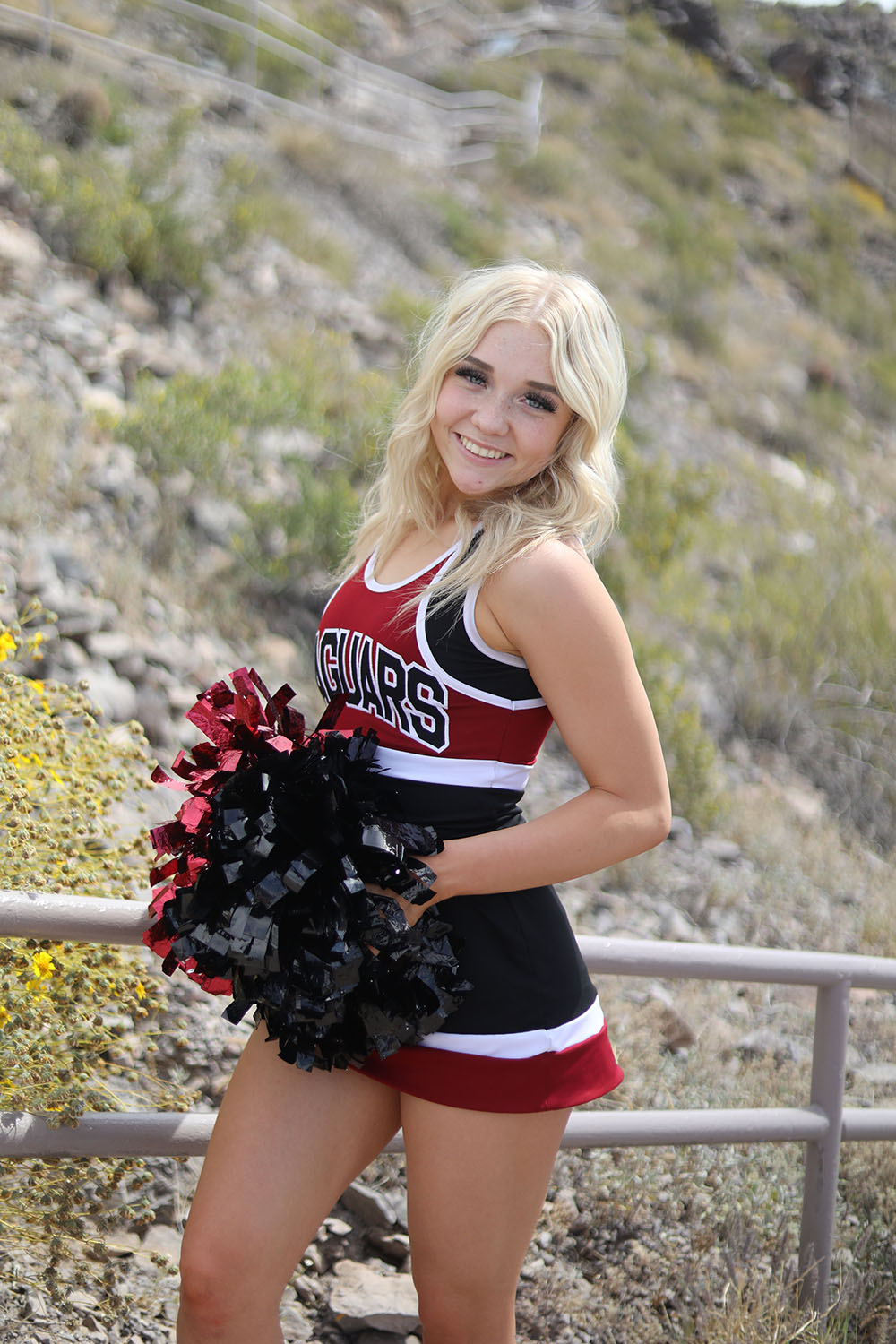 Cheerleader posing on A Mountain in Tempe AZ