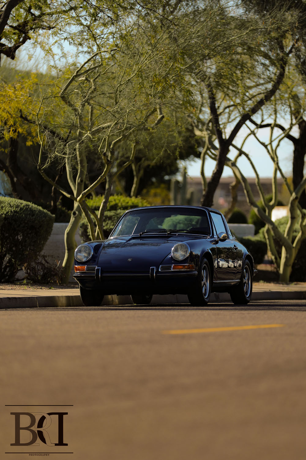 Black Porsche parked on the side of the road