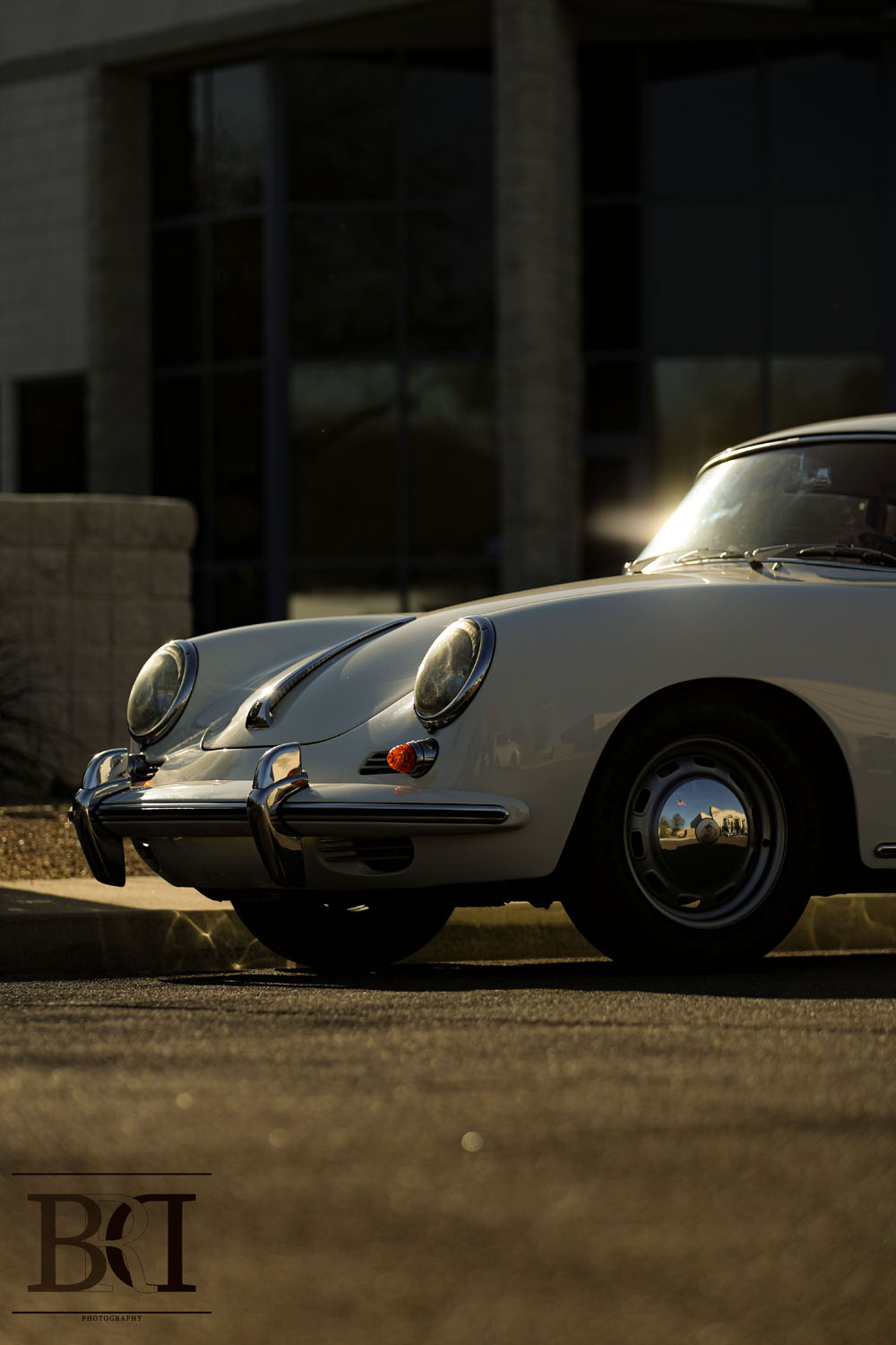 Half a Porsche parked in the street