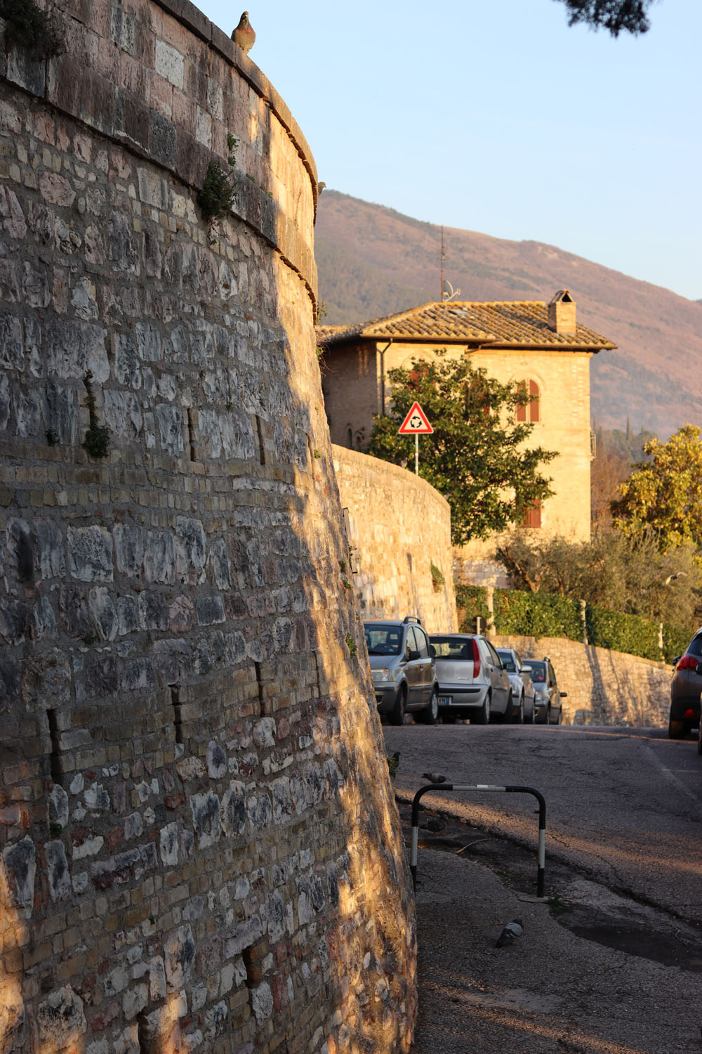 Cars parked by a stone wall