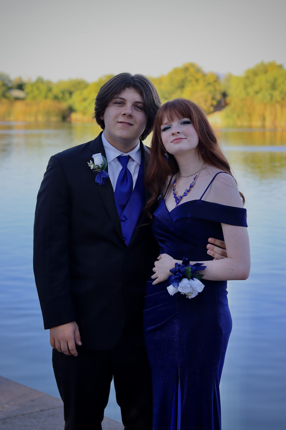 A couple in front of a pond