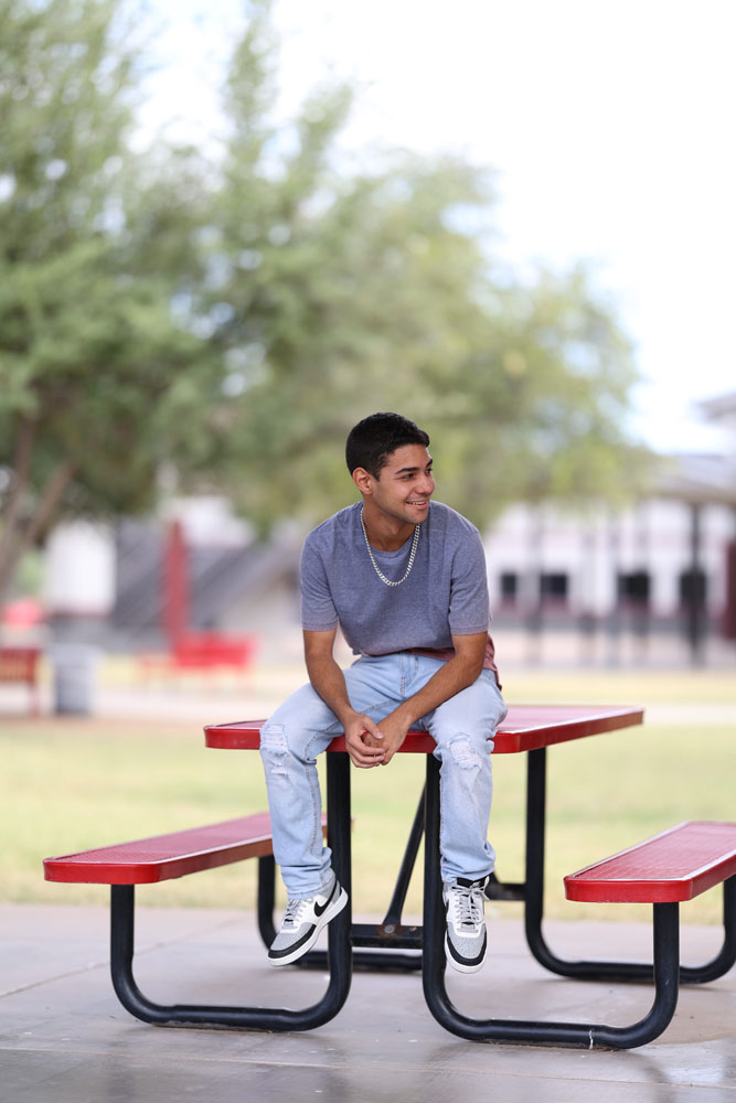 A student sitting on a bench in the courtyard