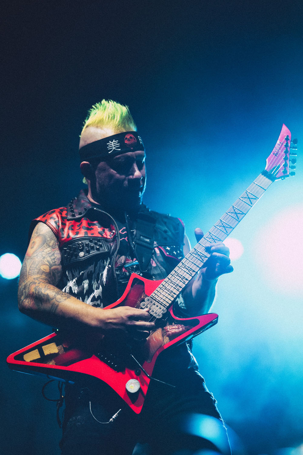 Guitarist playing in blue light