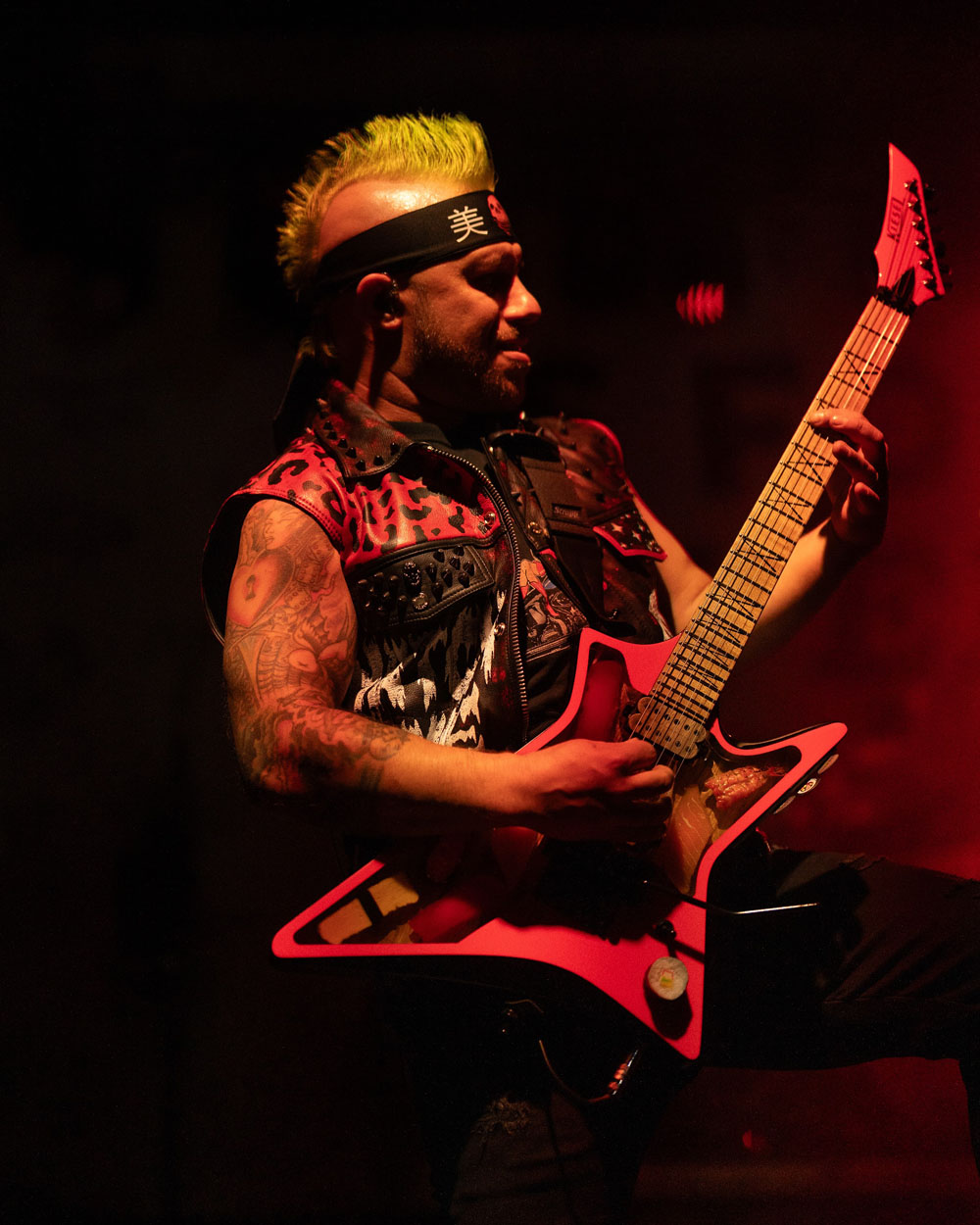 Guitarist playing in red light