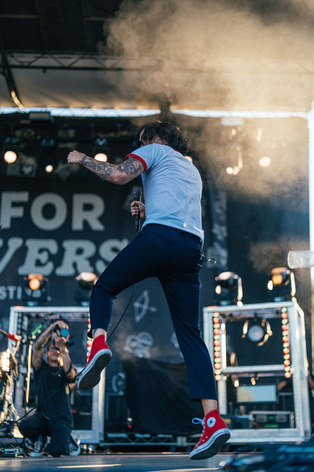 Singer jumping while in fog