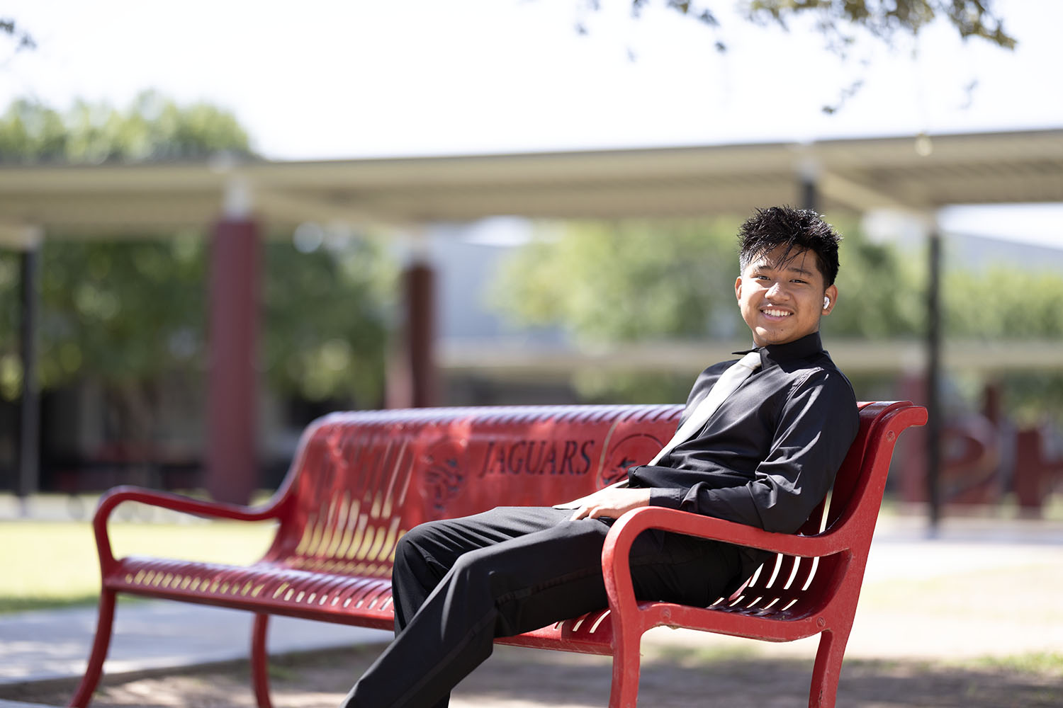 Victor smiling on a bench