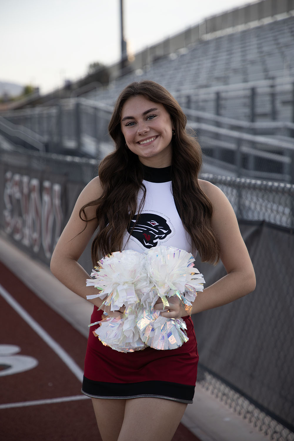 Ava smiling by the bleachers at DRHS