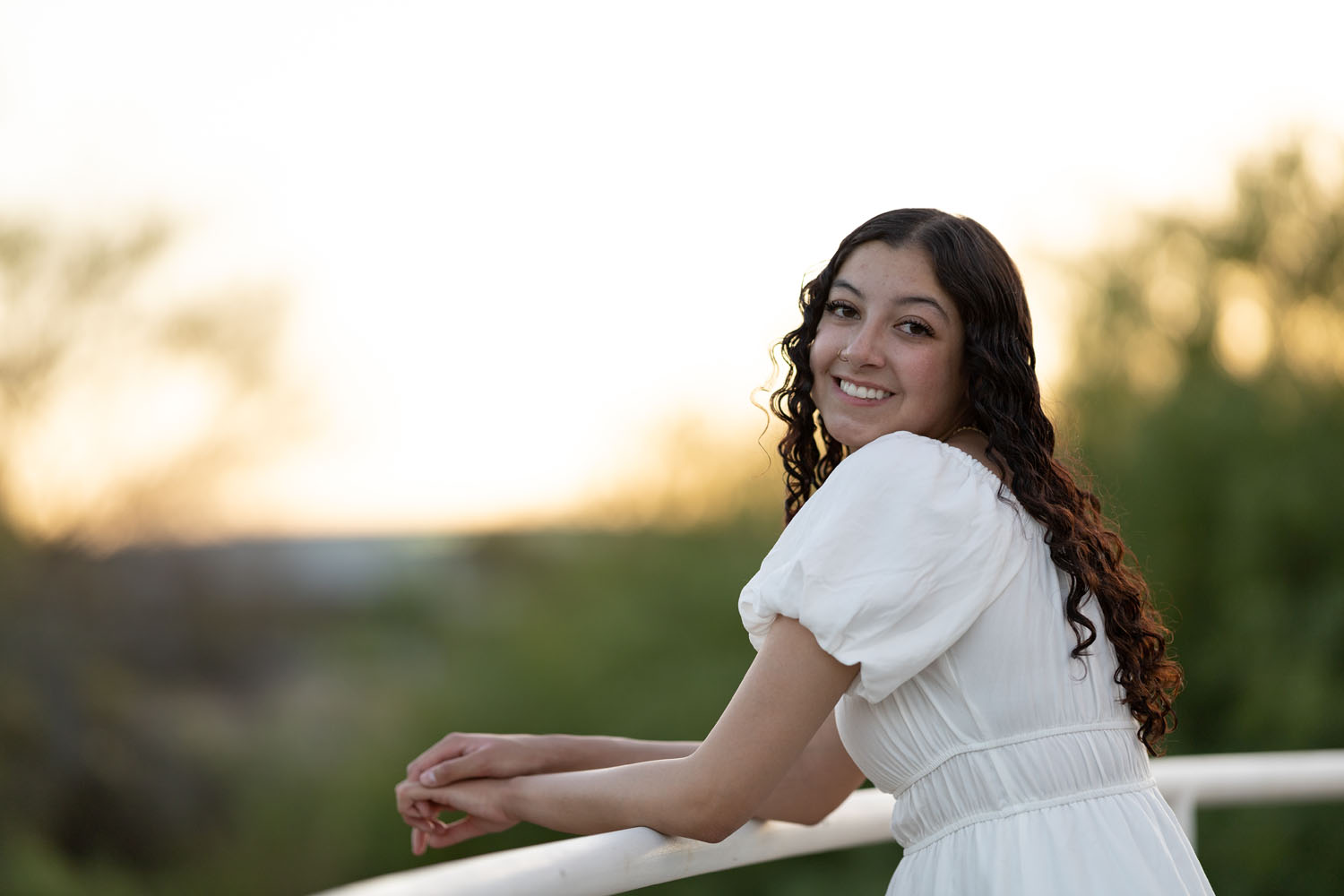 Young lady smiling for the camera at dusk