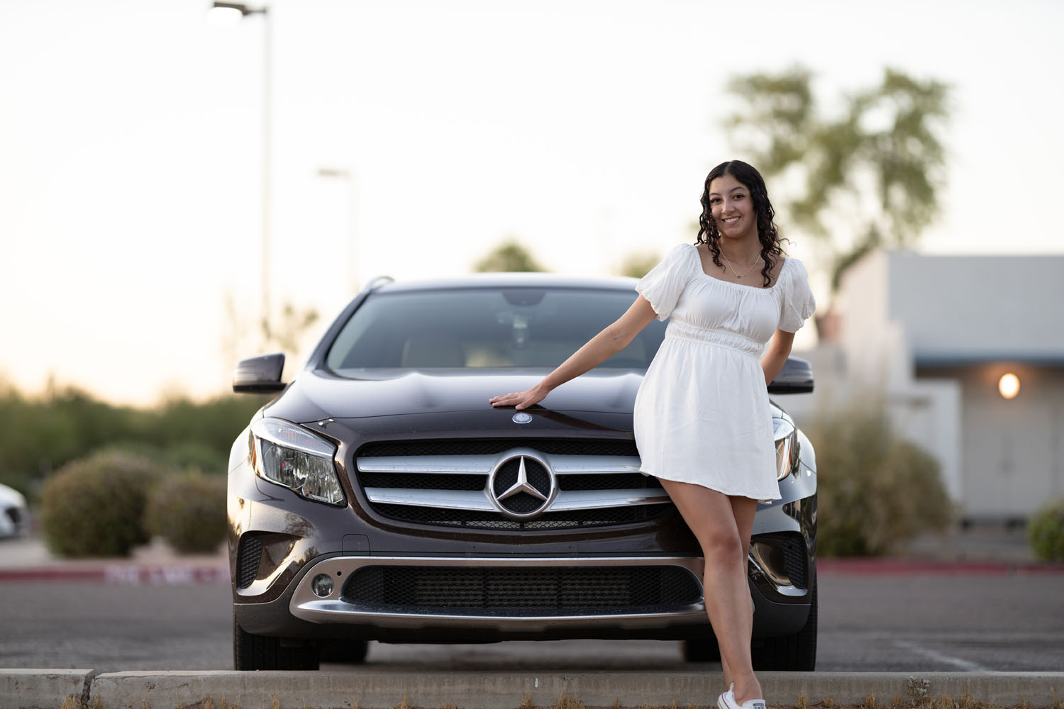 Young Lady next to a car smiling