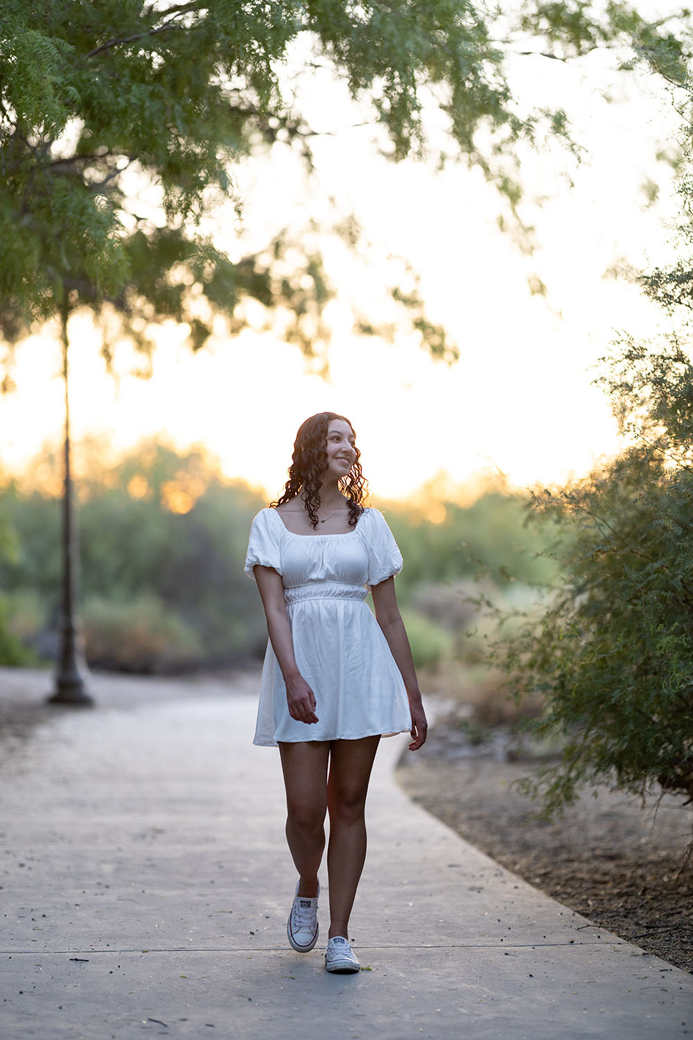 Young Lady walking down a sidewalk