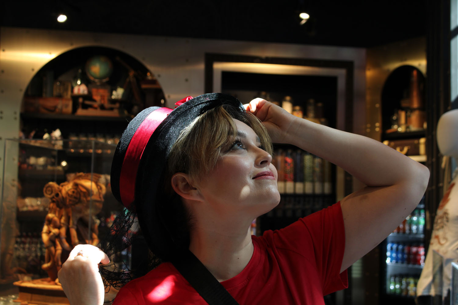 Mom looking up at the ceiling wearing a big hat