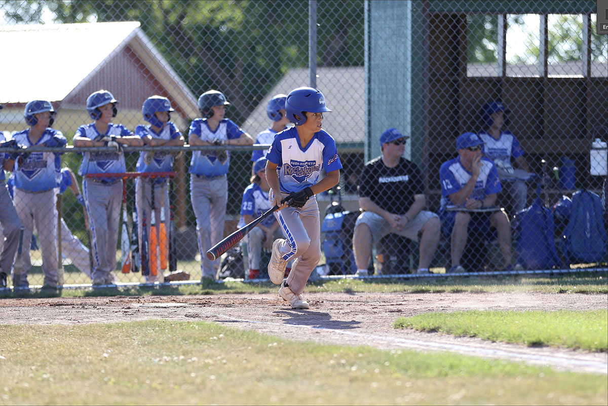 Evan hitting the ball and running