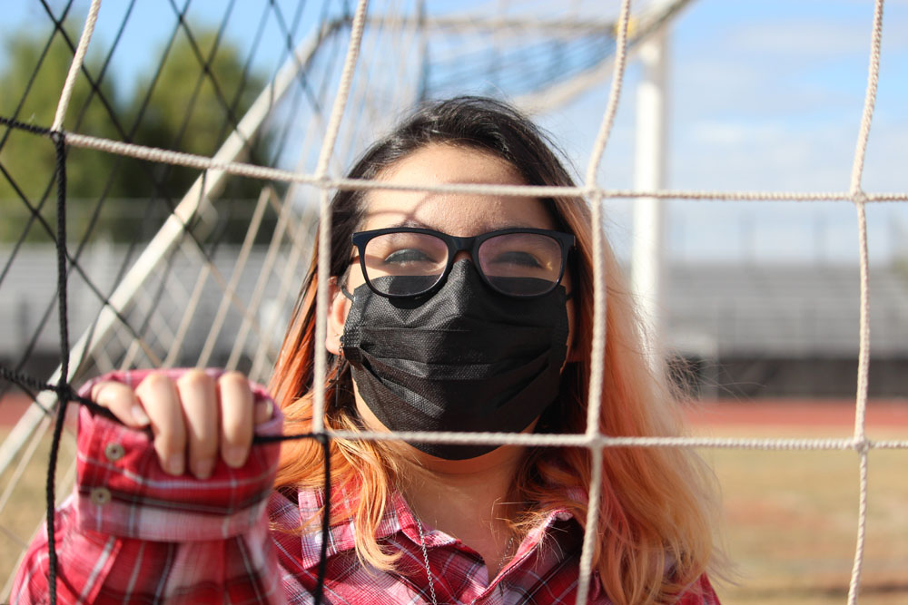 Girl behind fence