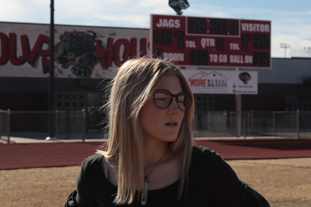 Hailee Wolfe in front of Jag's football locker