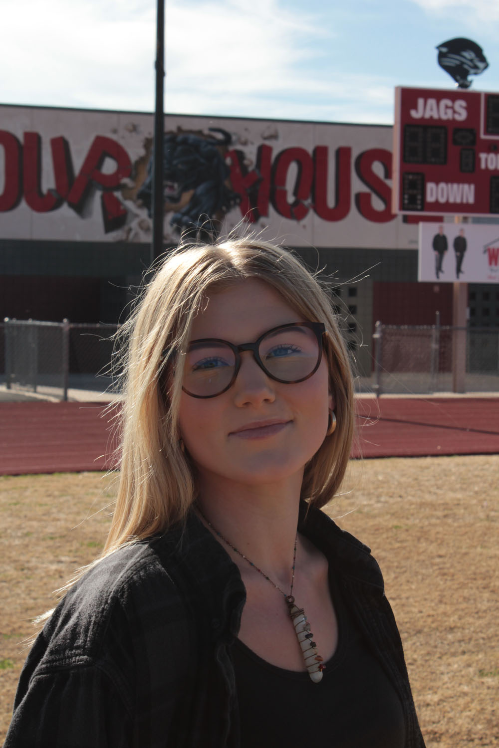 hailee posing in front of football field