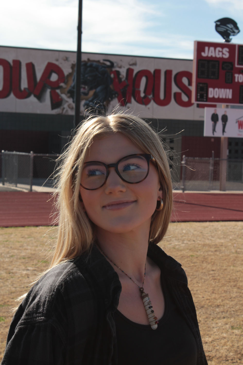 photo of hailee on the football field by scoreboard