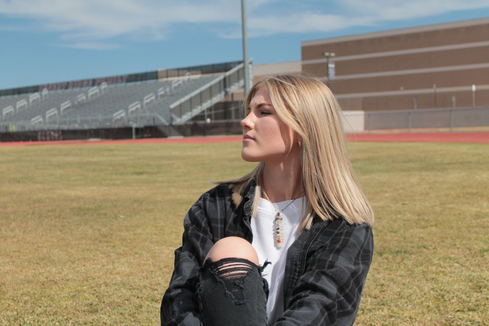 hailee sitting downon the football field