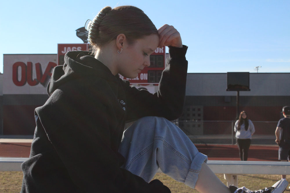 side-profile-of-kamry-sitting-on-the-bleachers