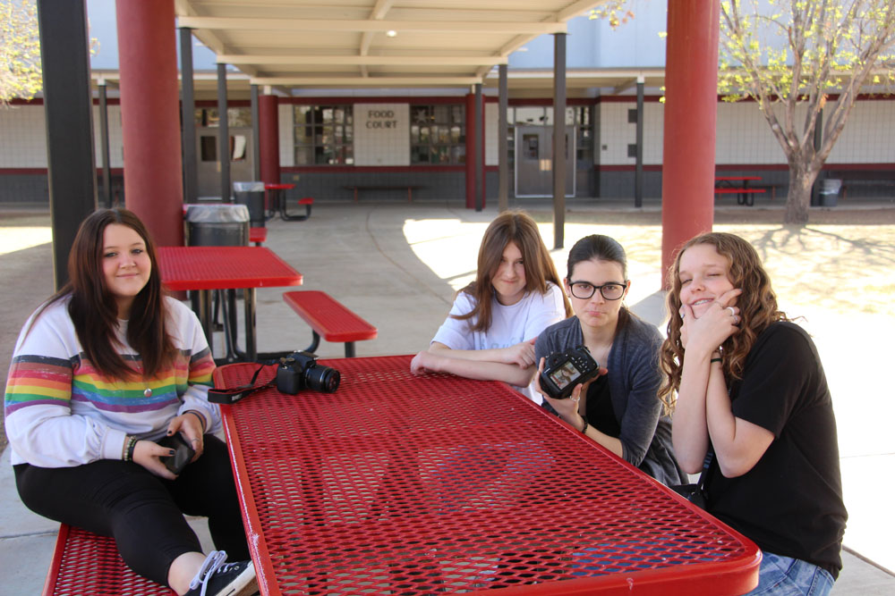 kadence-janey-shyann-kamry-sitting-on-a-red-bench