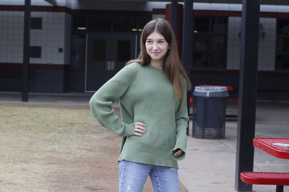 janey-standing-wearing-a-green-sweater