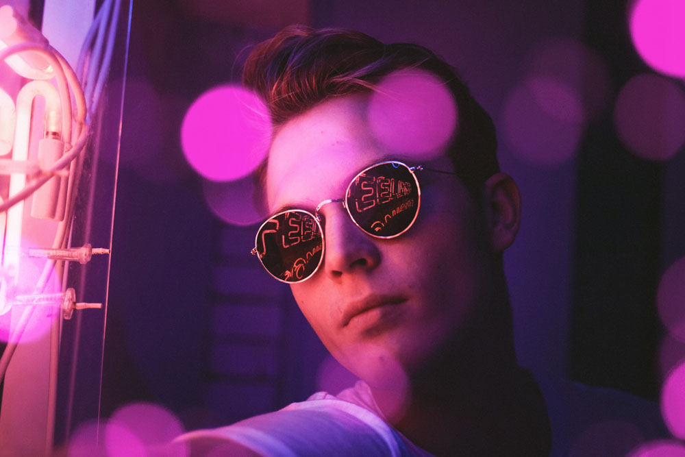 guy-with-sunglasses-in-purple-light