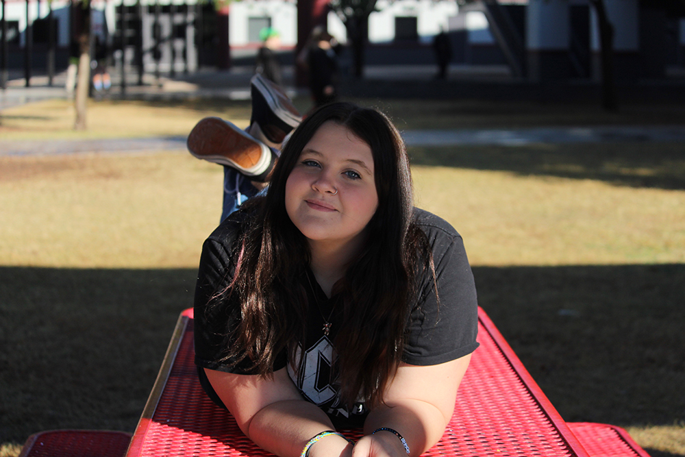 Kaydence posing on a bench.