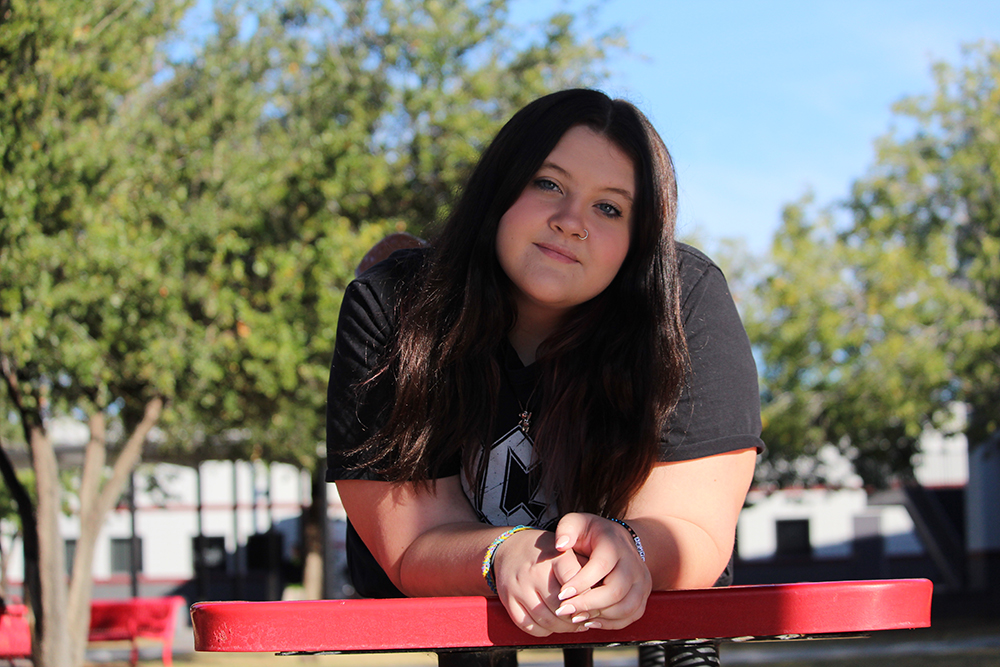 Kaydence posing on a bench.