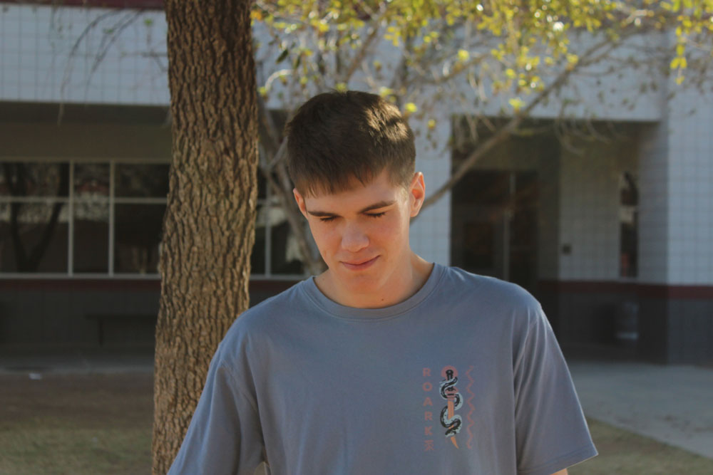 trey looking at a cool bug on floor