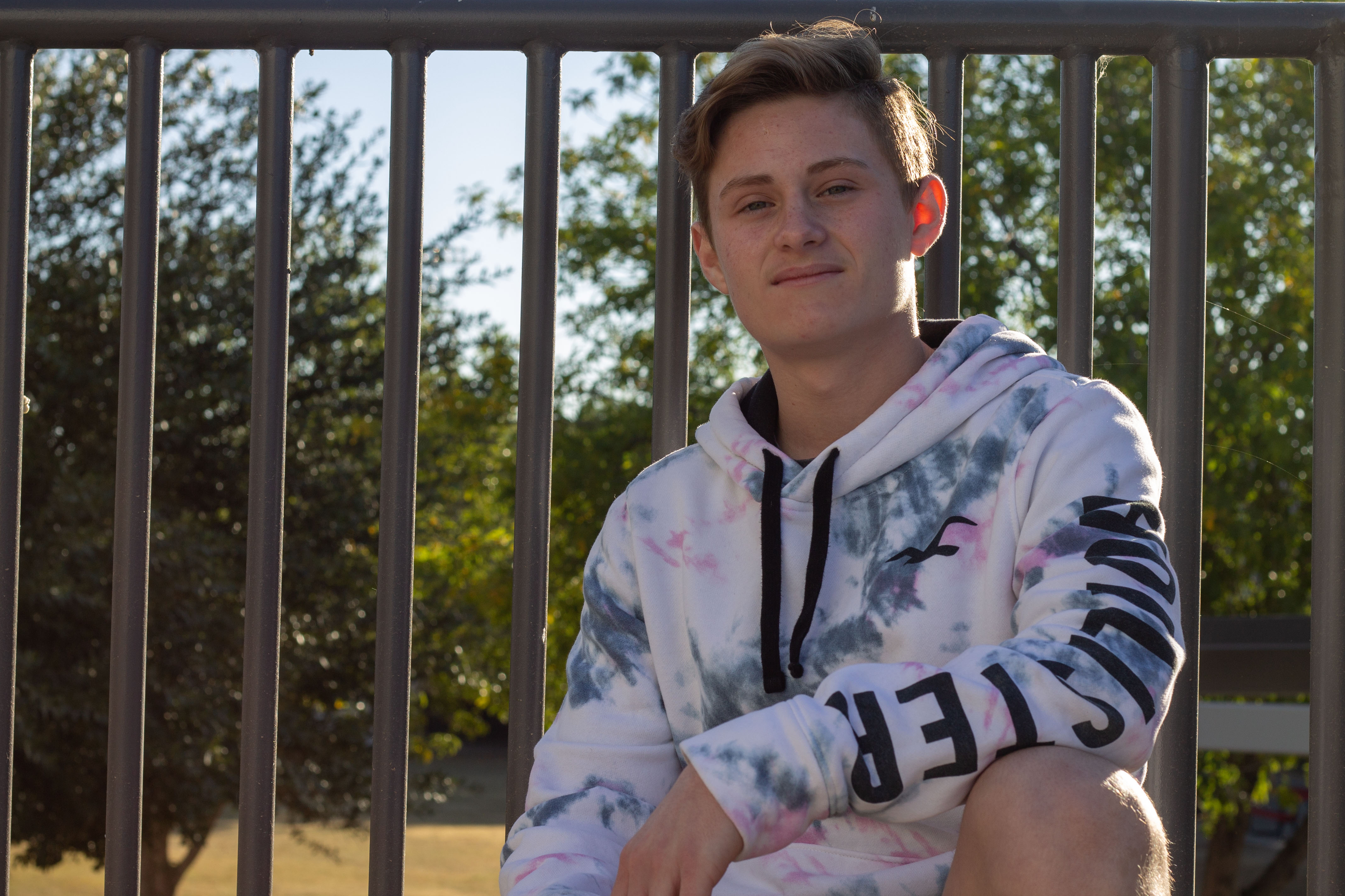 jayden against rail and trees