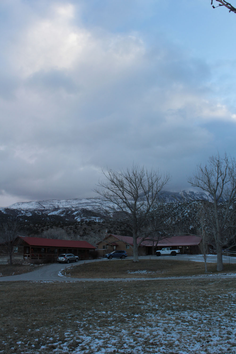 The neighboring cabin with snowy mountains in the background.