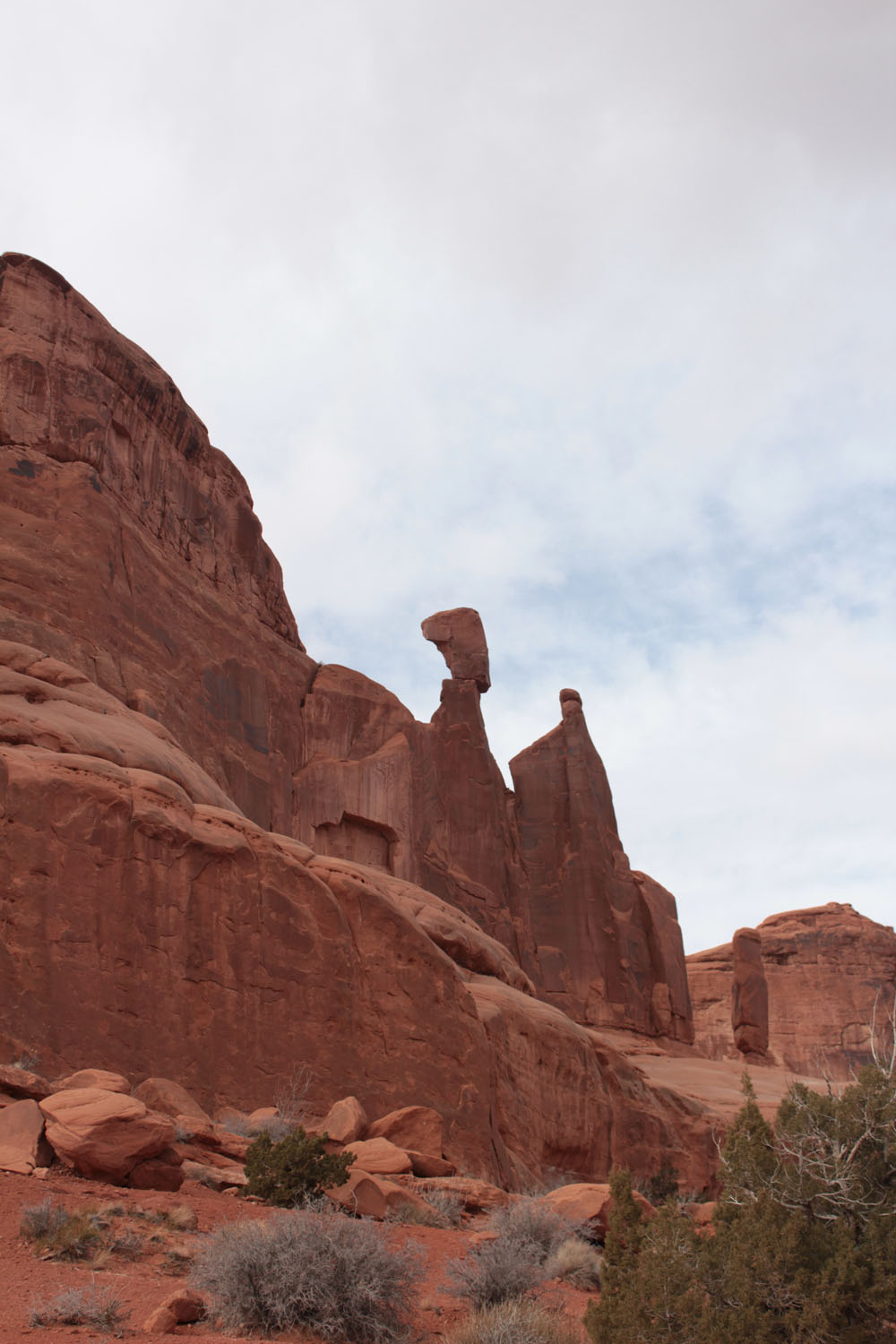 A rock balancing on the top of the rock formation.